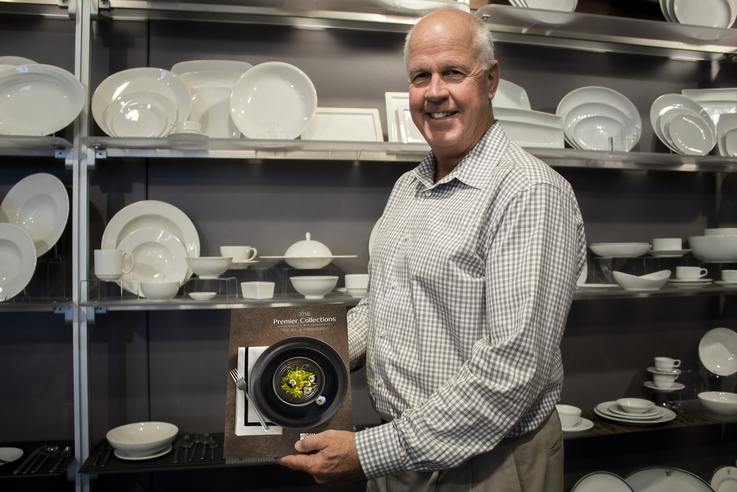 man holding china plate