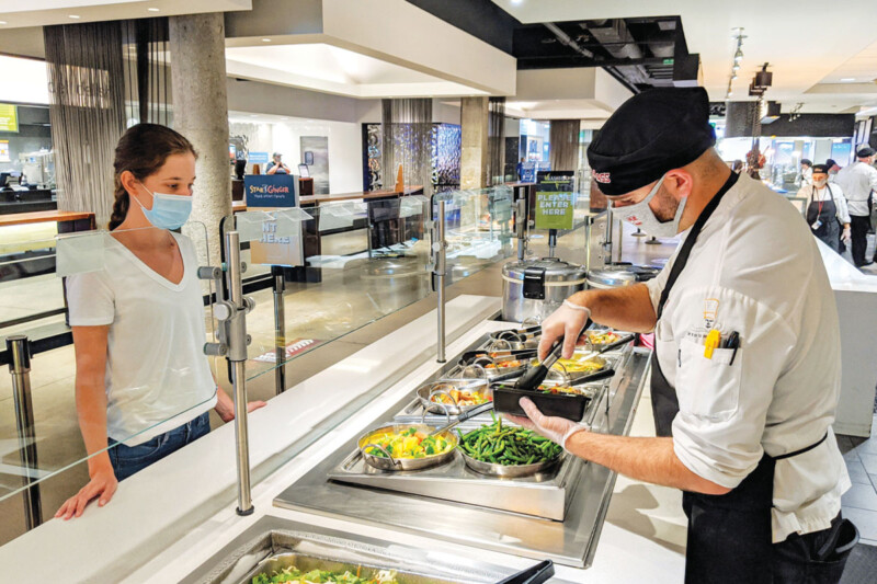 With self-service shelved for now, universities are offering staff-served dishes or prepackaged meals for carryout and delivery to limit dining room capacity. Photo courtesy of University of Massachusetts Amherst.