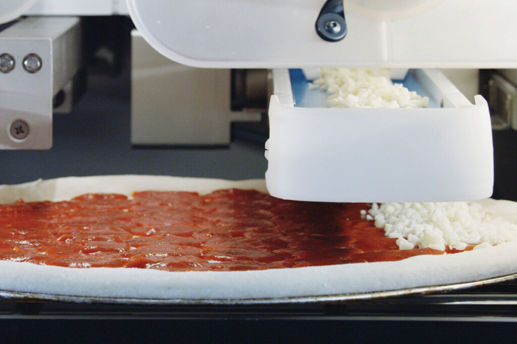 The pandemic
may give way to
entirely robotic
pizza kitchens.
This system automatically assembles pizzas and sends them directly to an oven, reducing human contact with menu ingredients. Courtesy of Picnic.