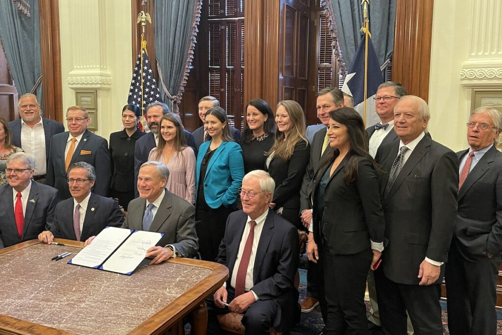 (Front, left to right) Lt. Gov. Dan Patrick, Sen. Kelly Hancock, Gov. Greg Abbott, Chairman Charlie Geren and others gather for a photo after the signing of Texas' new alcohol-to-go bill.