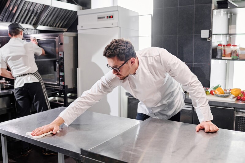 Staff cleaning kitchen after work