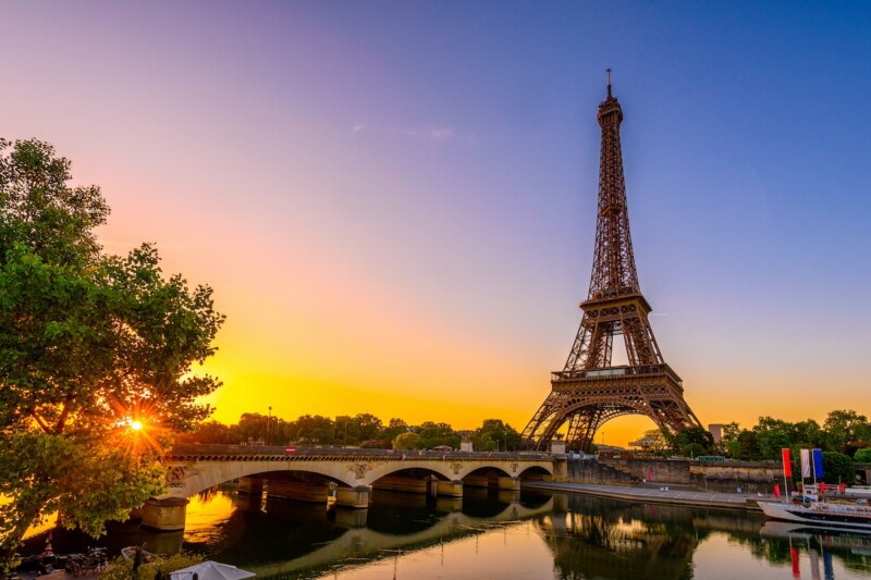 View of Eiffel Tower and river Seine at sunrise in Paris, France. Eiffel Tower is one of the most iconic landmarks of Paris